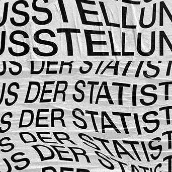 Close-up of fabric with repeated German text in black on white.