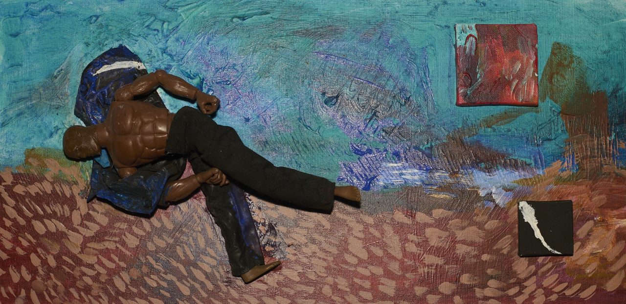 Person painting a colorful, textured wall outdoors.