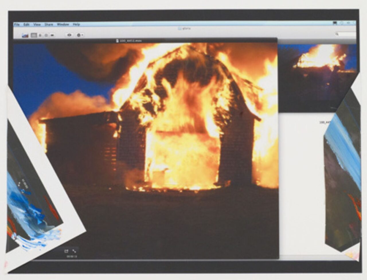 A burning house engulfed in flames at night.