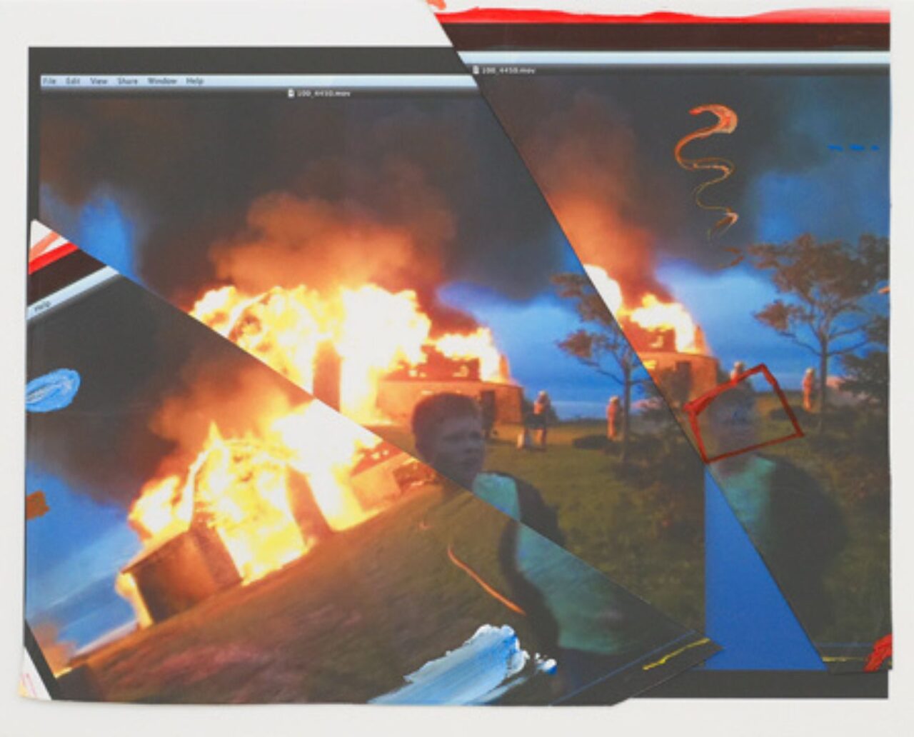 A firefighter battling a large blaze at night near a building.